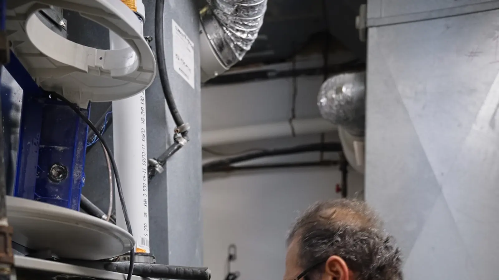 H&C technician working inside a furnace cabinet
